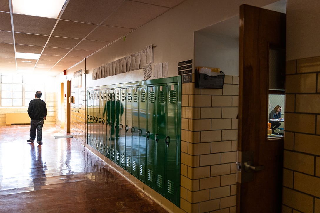 A teacher walks down an empty hallway at an elementary school in Kentucky, January 2022. (GettyJon Cherry)