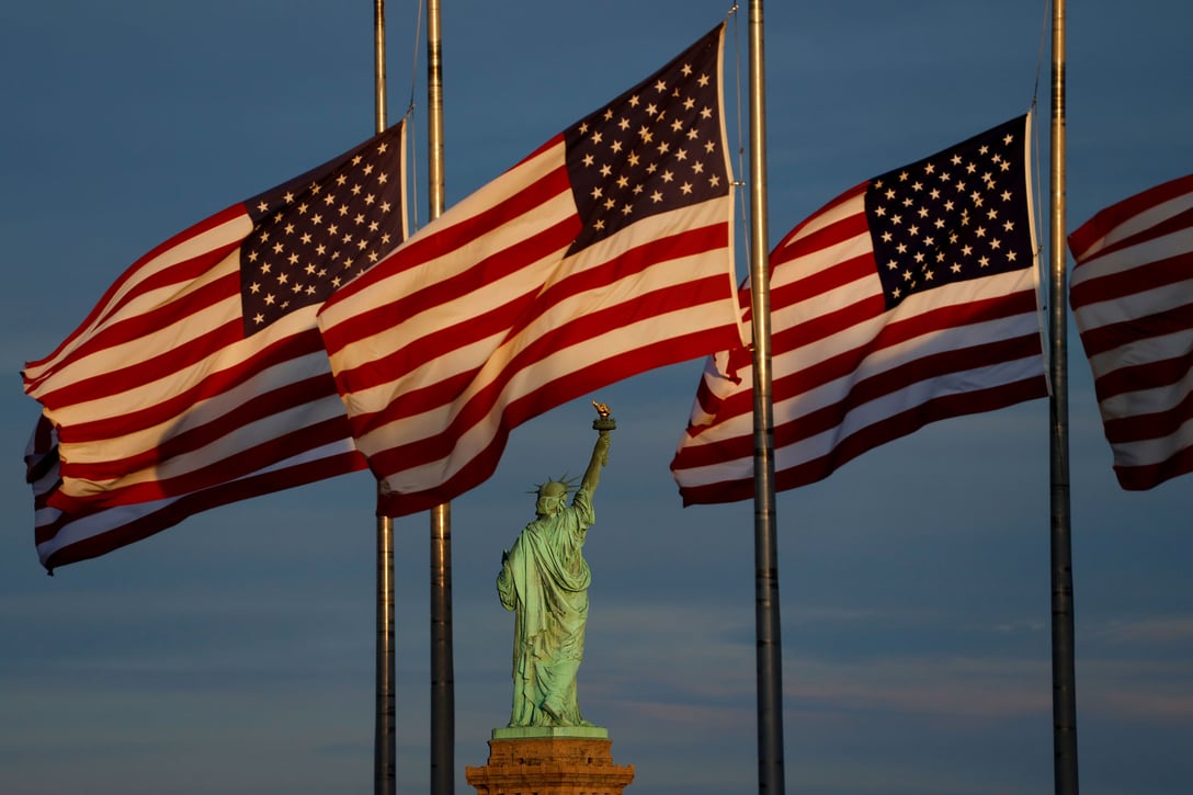American flags wave behind the Statue of Liberty in New York City, August 31, 2025. (Getty/Gary Hershorn)