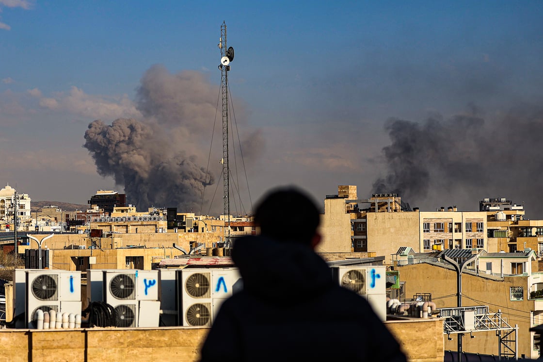 A person observes smoke rising in the distance after explosions were reported in Tehran, Iran, on March 2, 2026. (Getty/Contributor)