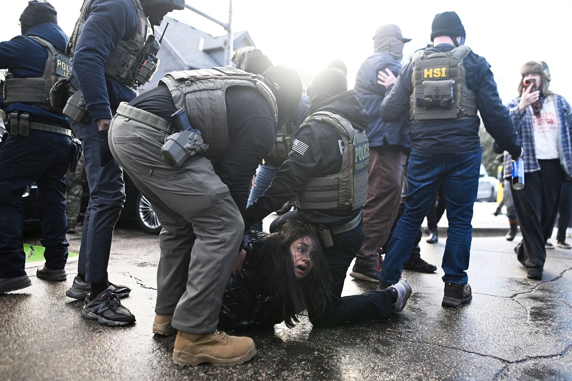 ICE agents detain a woman after pulling her from a car, January 13, 2026, in Minneapolis. (Getty/Stephen Maturen)