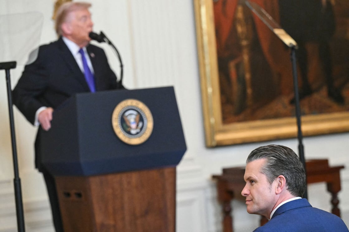 Secretary of Defense Pete Hegseth looks on as President Donald Trump speaks, March 2026. (Getty/Saul Loeb)