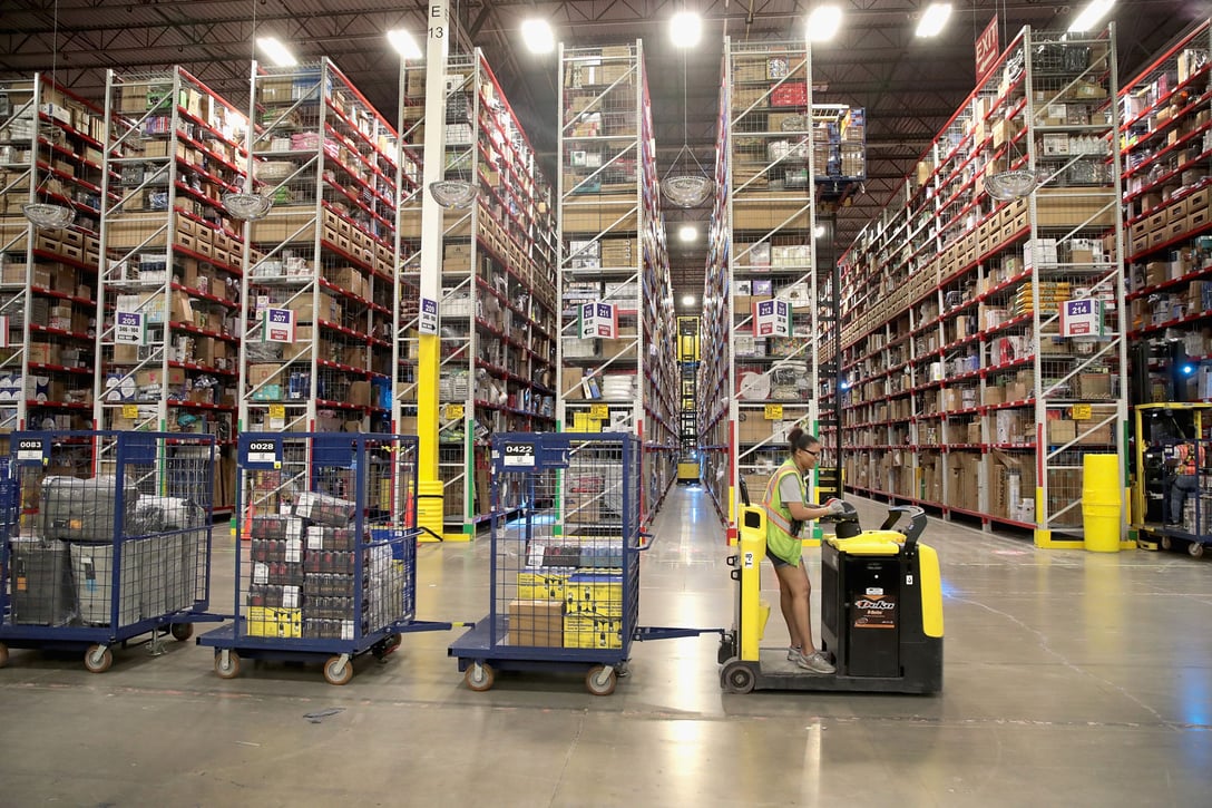 Workers pack and ship customer orders at an Amazon fulfillment center in Romeoville, Illinois, August 1, 2017. (Getty/Scott Olson)