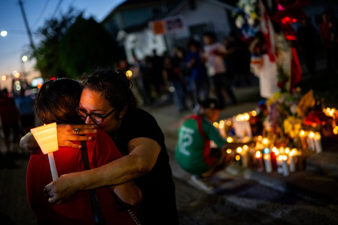 People embrace as they pay their respects during a candlelight vigil for a Mexican immigrant who was fatally shot by a U.S. Immigration and Customs Enforcement (ICE) officer, July 8, 2026, in Houston. (Getty/Brandon Bell)